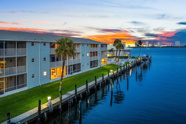 view of dock featuring a yard and a water view