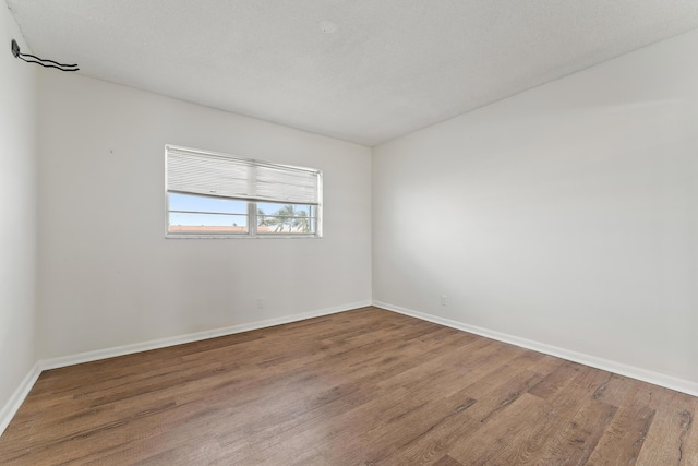 unfurnished room with hardwood / wood-style floors