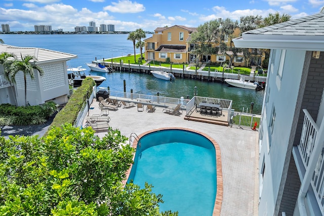 view of swimming pool featuring a water view, central AC unit, and a patio area