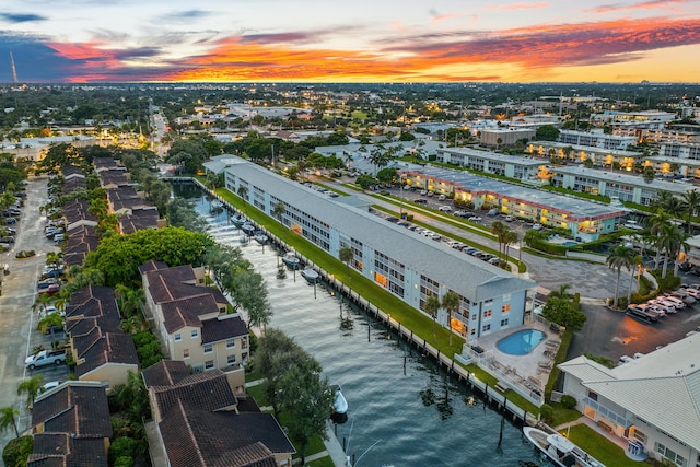 aerial view at dusk featuring a water view