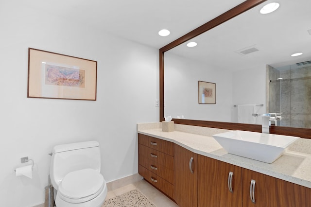 bathroom with tile patterned flooring, vanity, an enclosed shower, and toilet