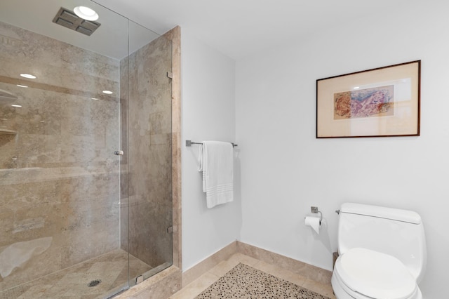 bathroom featuring tile patterned flooring, an enclosed shower, and toilet