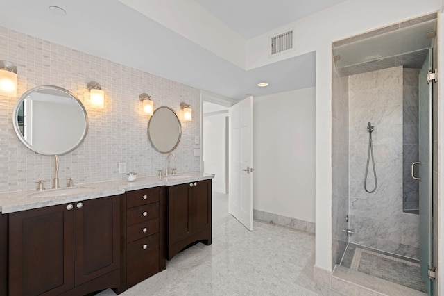 bathroom with tasteful backsplash, vanity, tile walls, and an enclosed shower