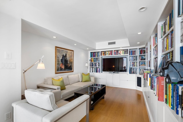 living room featuring hardwood / wood-style flooring and built in features