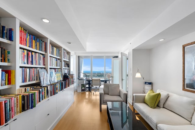 living area featuring floor to ceiling windows and light hardwood / wood-style floors