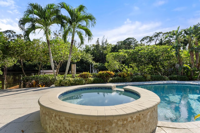 view of pool with an in ground hot tub