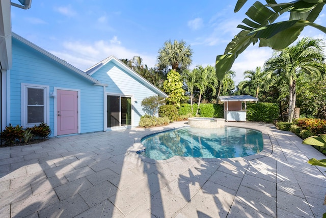 view of pool featuring a patio and an in ground hot tub