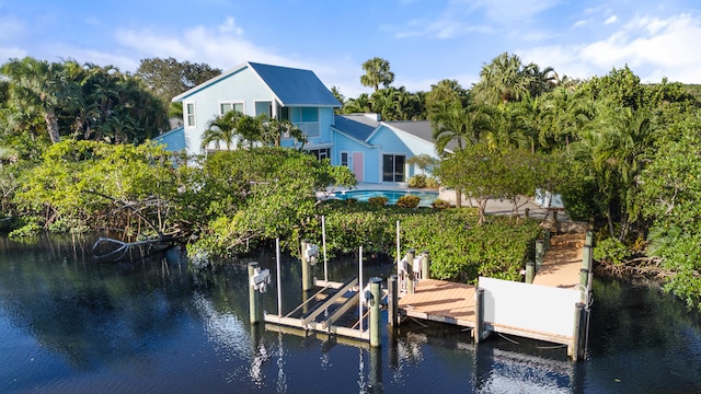 dock area with a water view and a balcony