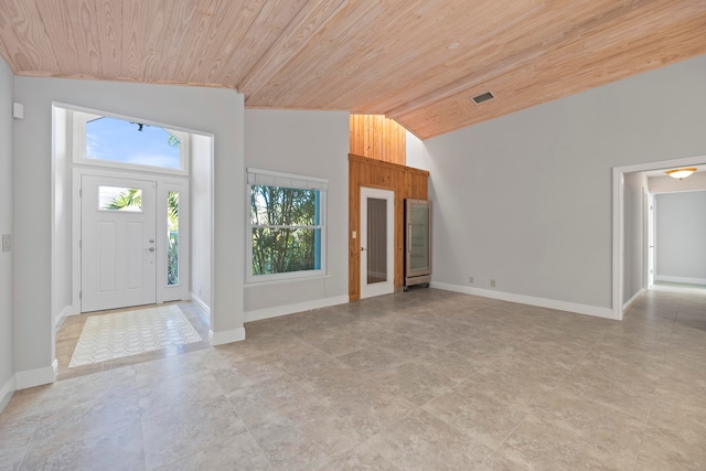 entryway with a healthy amount of sunlight, vaulted ceiling, and wood ceiling