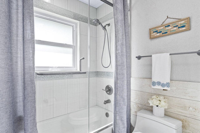 bathroom featuring shower / bath combination with curtain and toilet