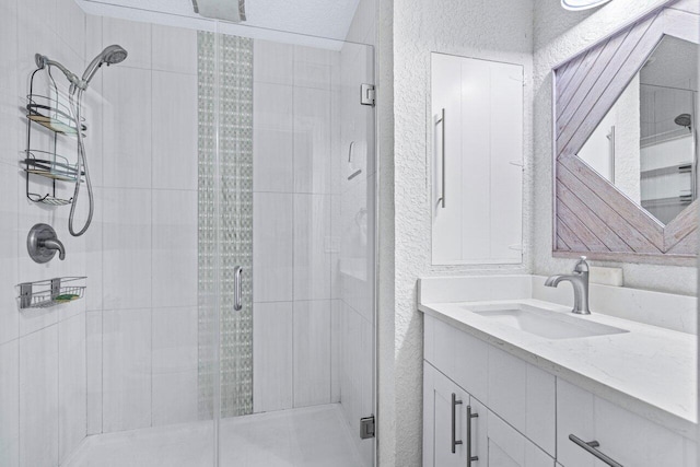 bathroom featuring vanity and an enclosed shower