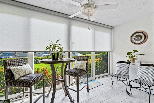 sunroom with ceiling fan