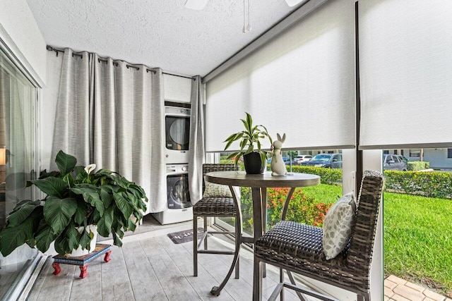 balcony featuring stacked washer and clothes dryer