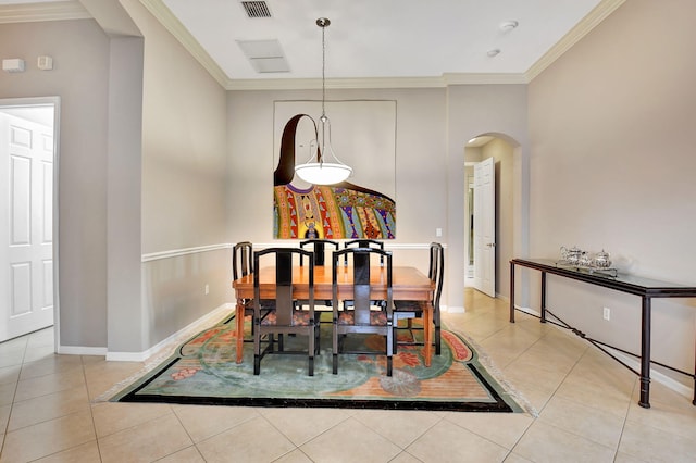 dining area featuring light tile patterned floors and crown molding