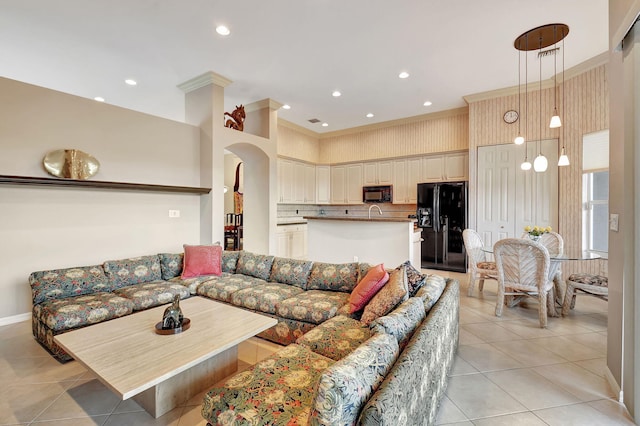 living room with light tile patterned flooring and ornamental molding