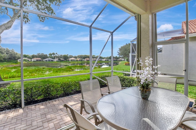 sunroom / solarium with a water view