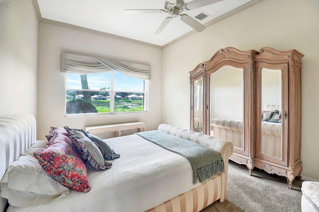 carpeted bedroom featuring ceiling fan and ornamental molding