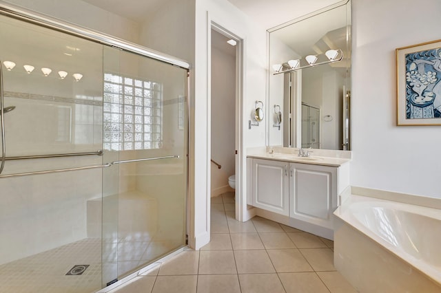 full bathroom featuring tile patterned floors, vanity, shower with separate bathtub, and toilet