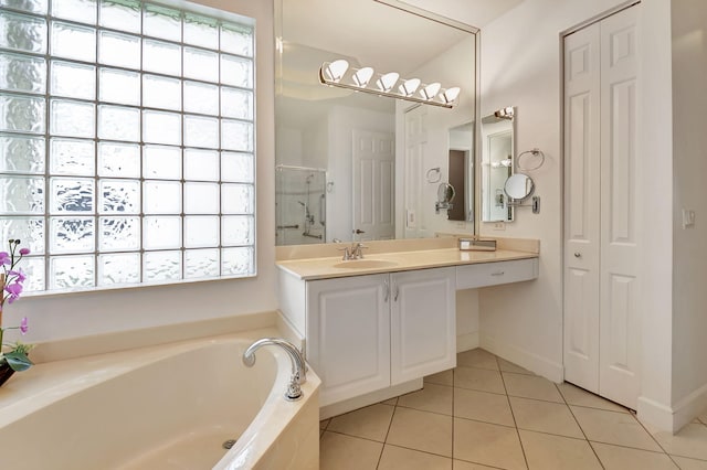 bathroom with tile patterned flooring, vanity, and separate shower and tub