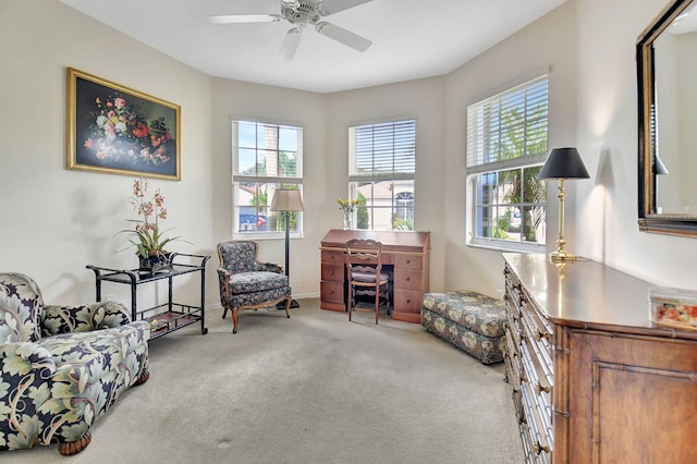 sitting room featuring light colored carpet, plenty of natural light, and ceiling fan