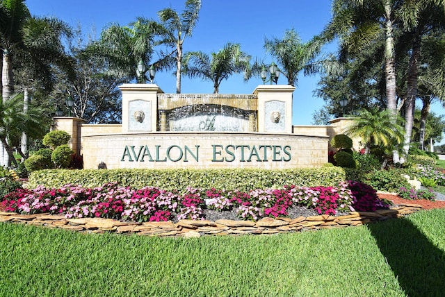 community / neighborhood sign with a lawn