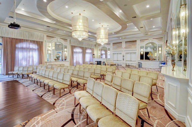 cinema with beam ceiling, light wood-type flooring, ornamental molding, and coffered ceiling