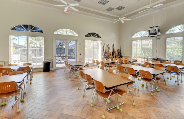 dining space featuring a high ceiling, plenty of natural light, and ceiling fan