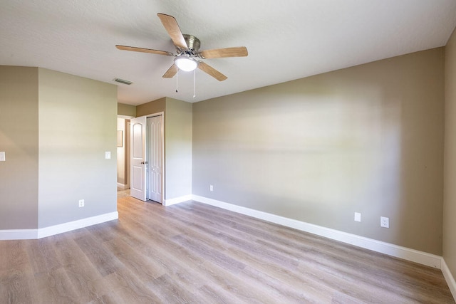 unfurnished room featuring ceiling fan and light wood-type flooring