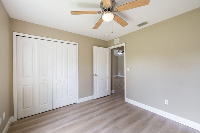 unfurnished bedroom featuring ceiling fan, a closet, and light hardwood / wood-style floors