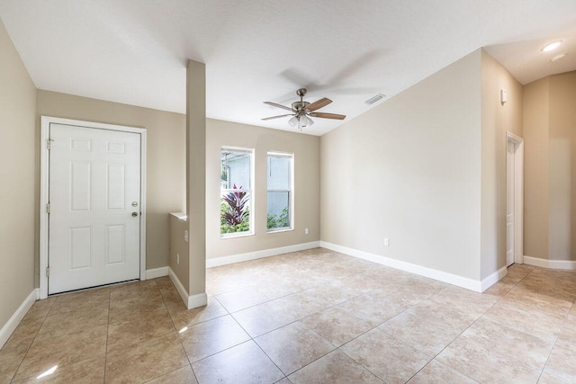 foyer entrance with light tile patterned floors and ceiling fan