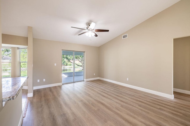 unfurnished living room featuring ceiling fan, light hardwood / wood-style flooring, and lofted ceiling