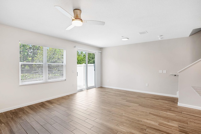 empty room featuring ceiling fan and light wood-type flooring