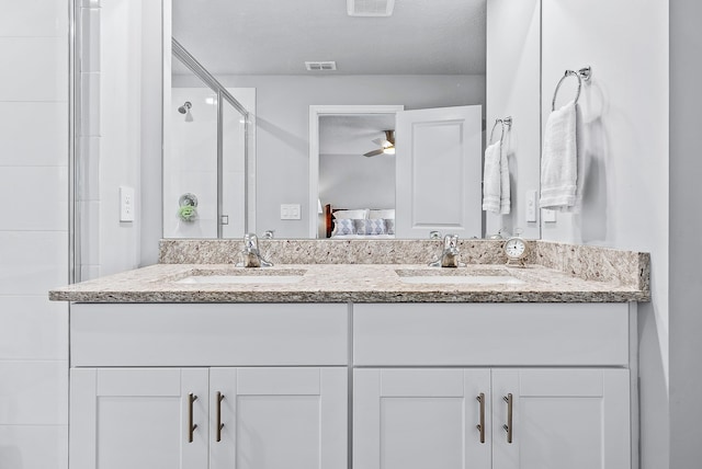 392 SE Sea Hunt Way, Stuart, FL 34994 - full bathroom featuring double vanity, a ceiling fan, ensuite bath, and a stall shower
