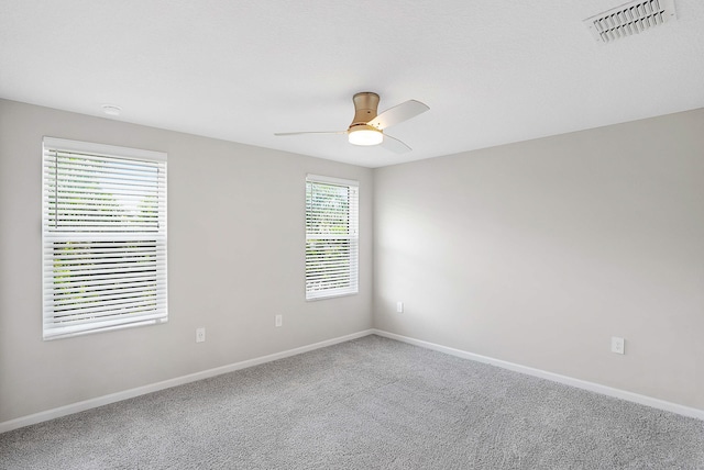 empty room featuring carpet and ceiling fan