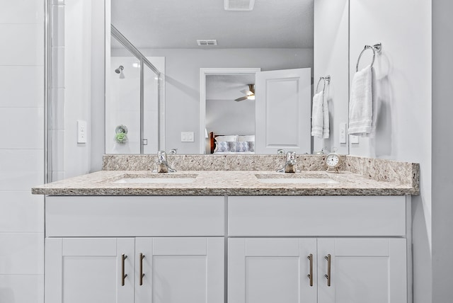 bathroom featuring vanity and an enclosed shower