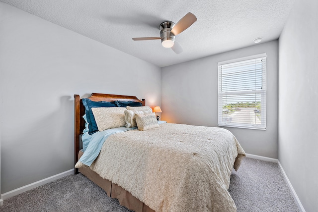 carpeted bedroom with ceiling fan and a textured ceiling