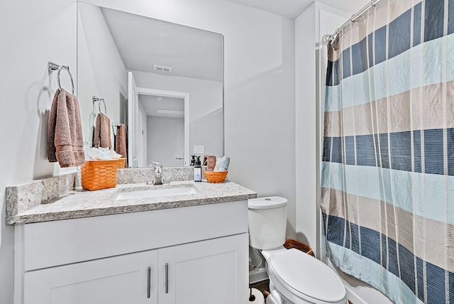 bathroom featuring vanity, a shower with shower curtain, and toilet