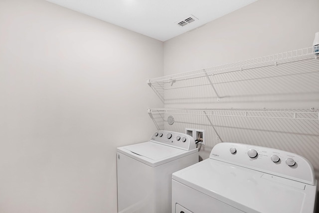 clothes washing area with independent washer and dryer