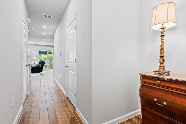 hall with wood-type flooring