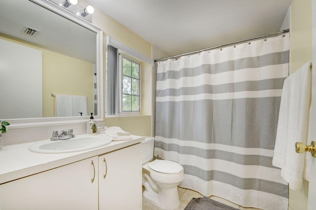 bathroom with vanity, tile patterned floors, and toilet