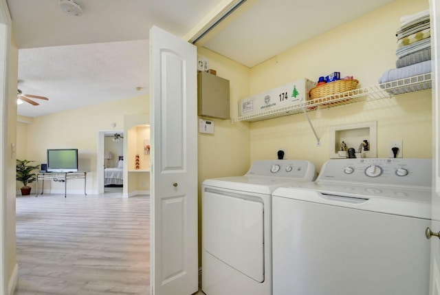 laundry room with light hardwood / wood-style floors, ceiling fan, a textured ceiling, and washer and dryer