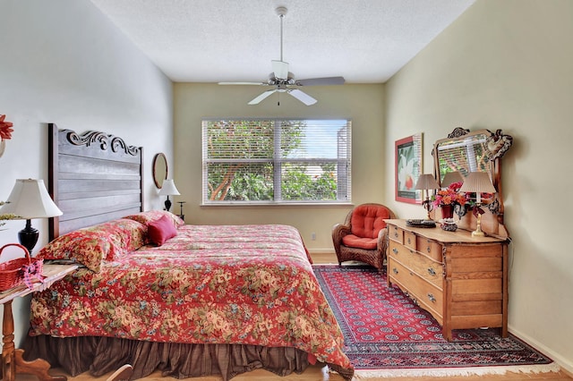 bedroom featuring a textured ceiling and ceiling fan