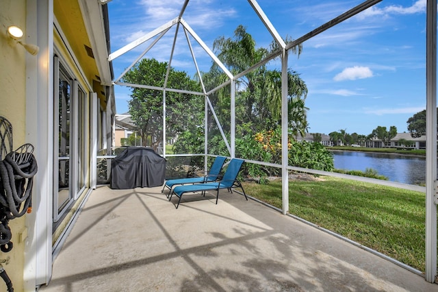 unfurnished sunroom featuring a water view