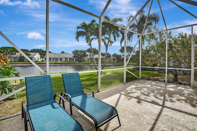 unfurnished sunroom featuring a water view