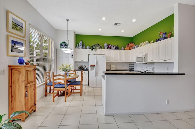 kitchen with decorative light fixtures, decorative backsplash, white appliances, and white cabinetry