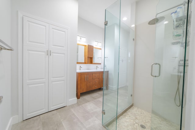 bathroom featuring vanity and an enclosed shower