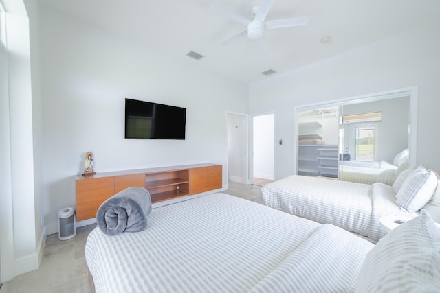 bedroom featuring ceiling fan, a closet, and light colored carpet