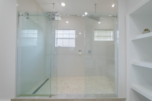 bathroom with a shower with door