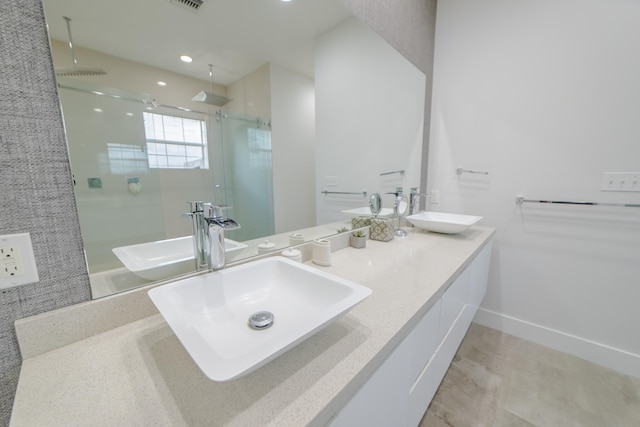 bathroom featuring vanity and a shower with shower door