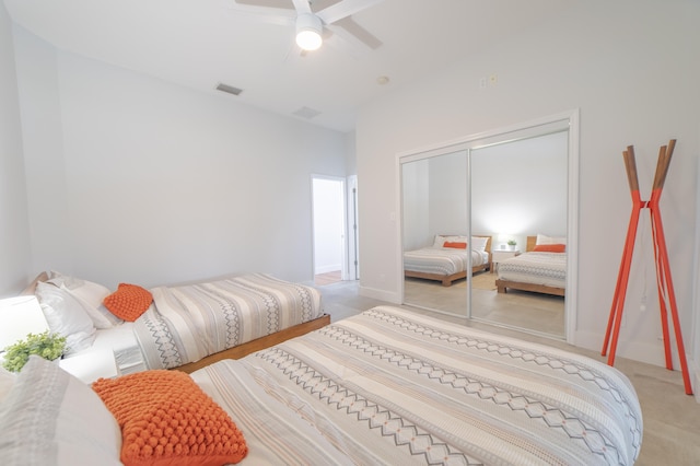 carpeted bedroom with a closet and ceiling fan